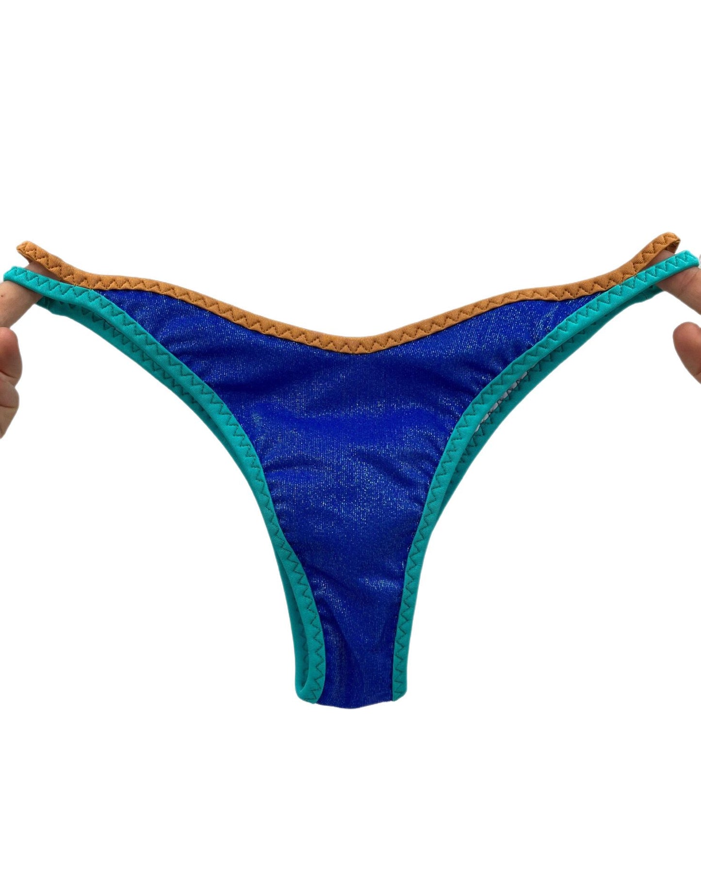 Close-up of Blue Sparkle Bikini Bottom with turquoise and camel brown contrast trim, front view.